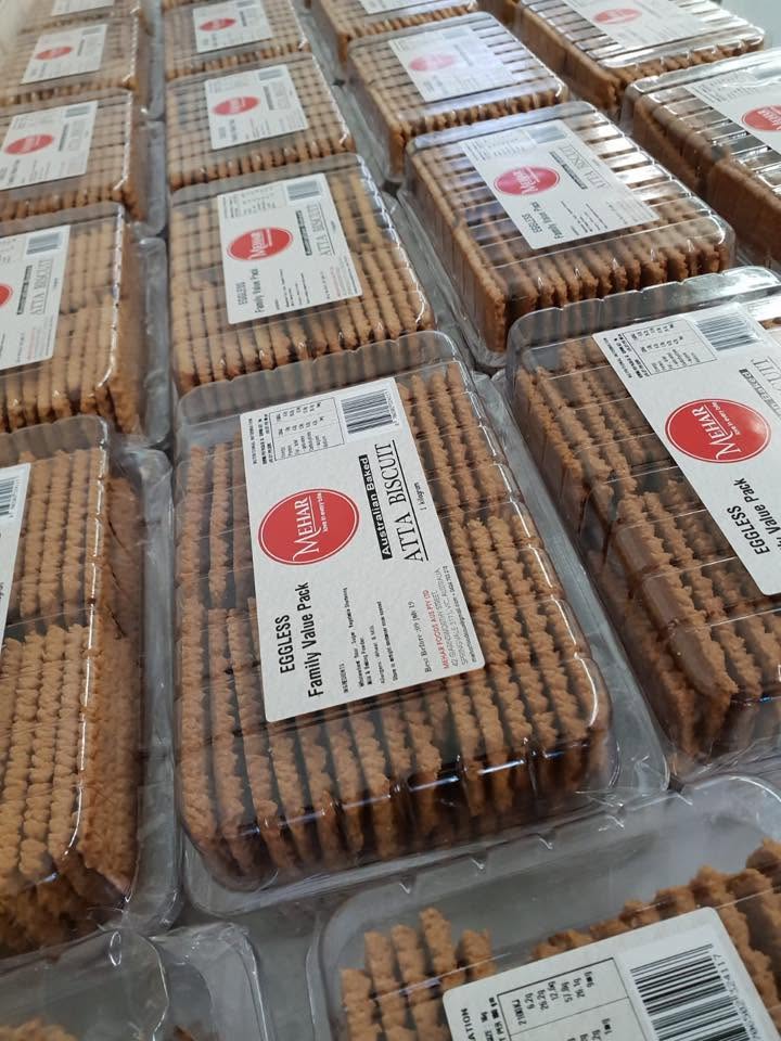 Trays of MEHAR FOODS AUS packaged biscuit products ready for distribution